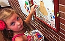 Savannah is creating a face using magnets